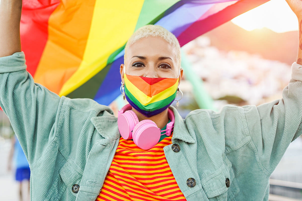 Woman holding a Gay Pride rainbow flag